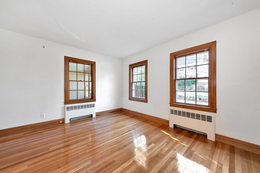 8 Tower Road Lexington, MA 02421 - Photo 20 of 39 an empty room with wooden floor and windows
