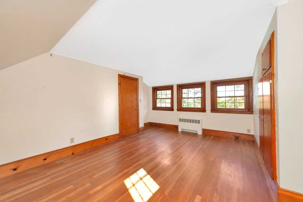 8 Tower Road Lexington, MA 02421 - Photo 24 of 39 an empty room with wooden floor and windows