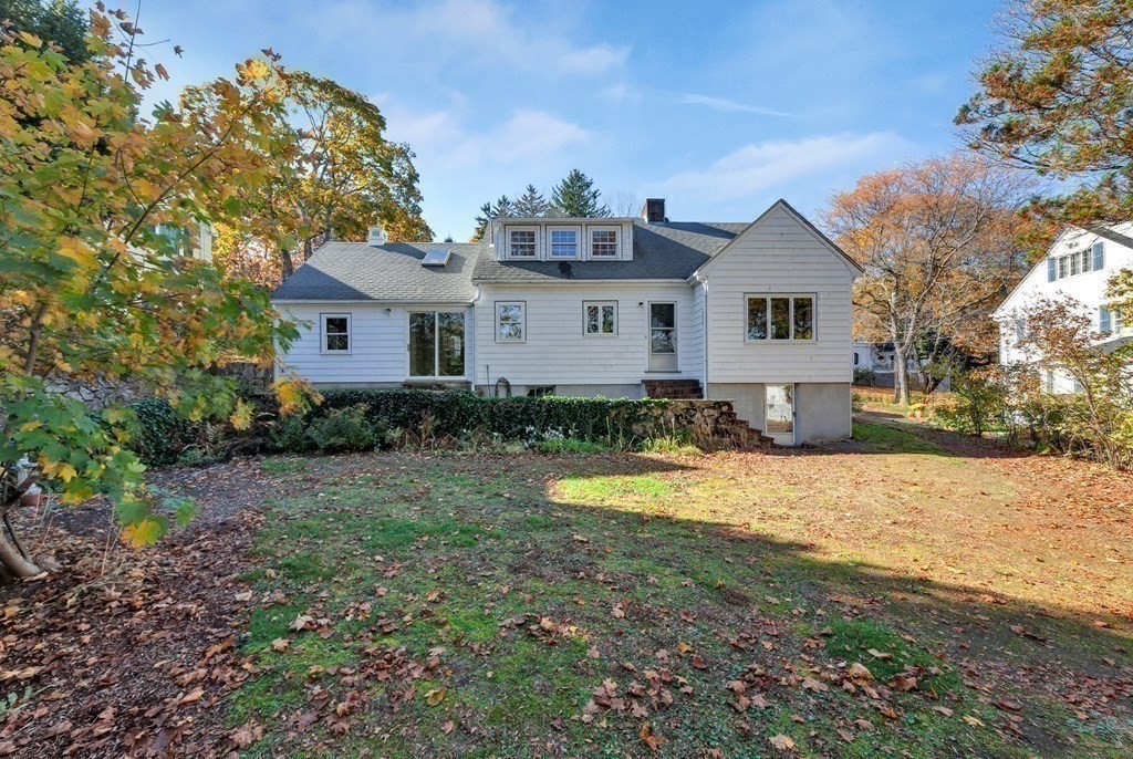 8 Tower Road Lexington, MA 02421 - Photo 36 of 39 a front view of a house with a yard and garage