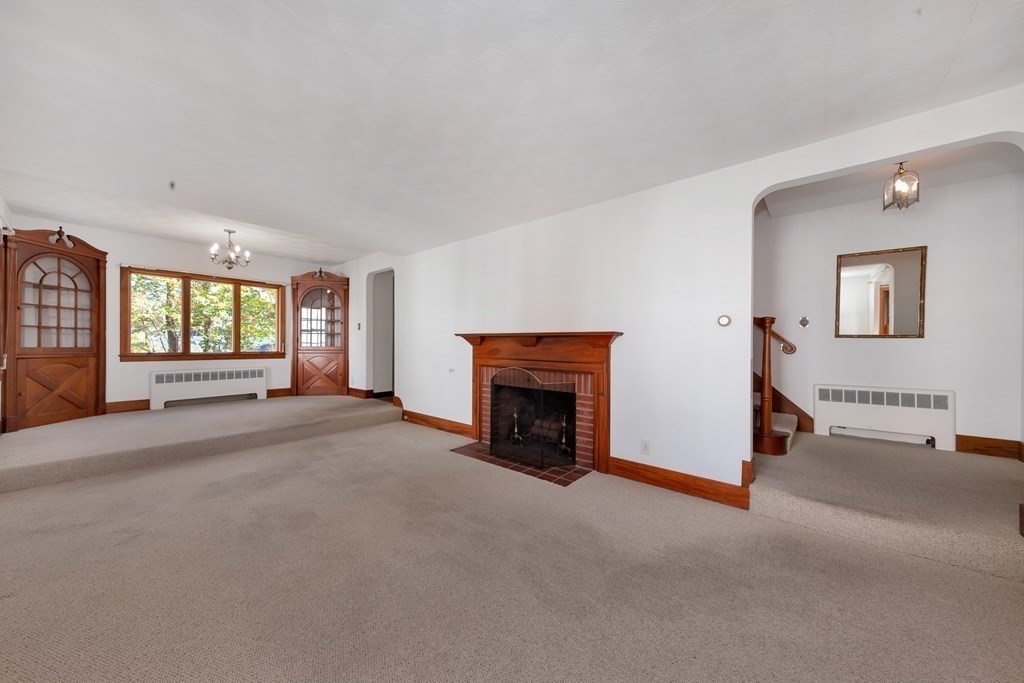8 Tower Road Lexington, MA 02421 - Photo 5 of 39 a view of a livingroom with an empty space and a fireplace