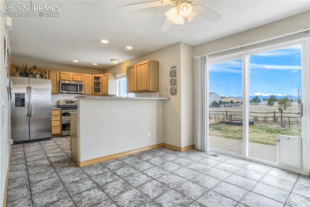 8820 Theriot Road Peyton, CO 80831 - Photo 17 of 50 Bar height breakfast nook is great for serving or hosting and easy backyard access.