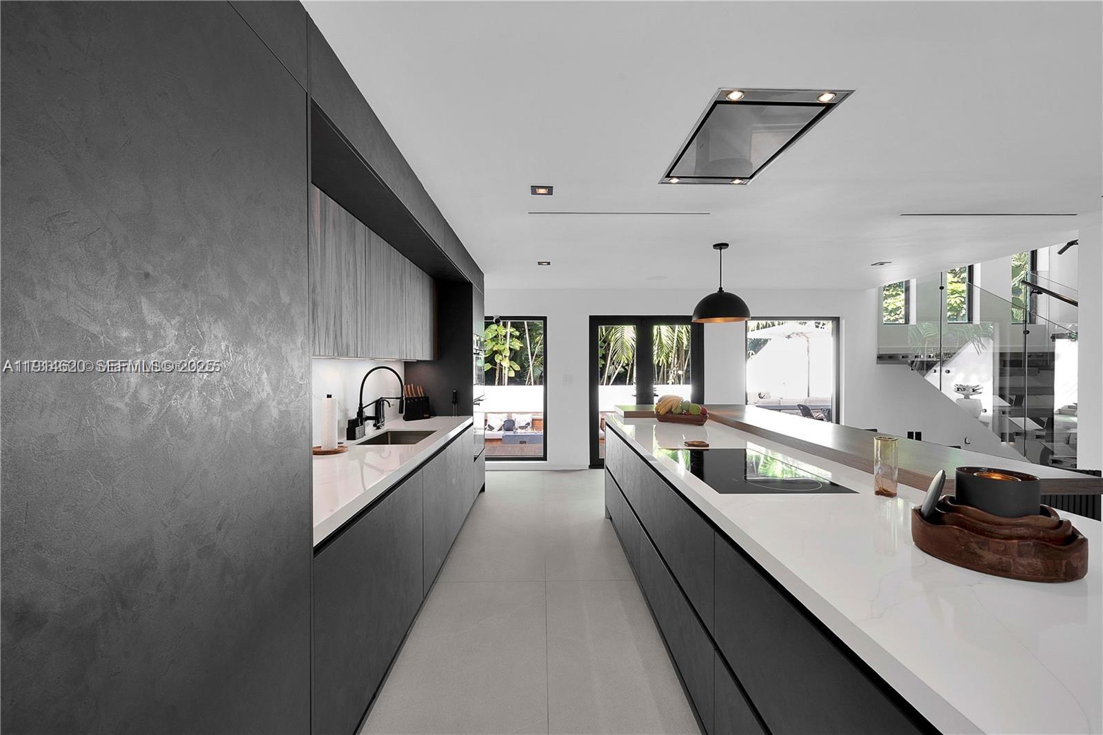 3760 Douglas Road Miami, FL 33133 - Photo 14 of 70 a large kitchen with a large counter top appliances and cabinets