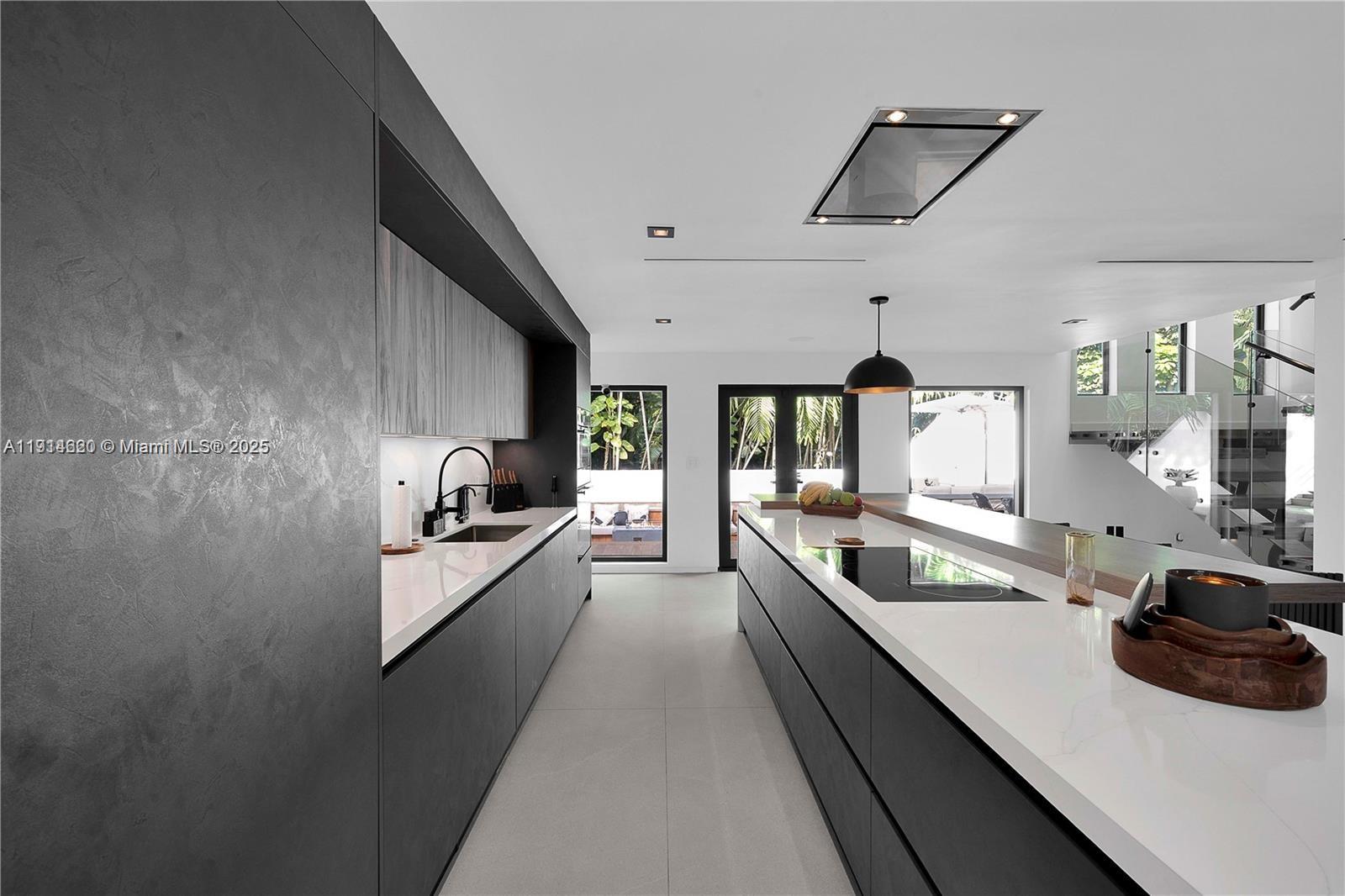 3760 Douglas Road Miami, FL 33133 - Photo 14 of 70 a large kitchen with a large counter top appliances and cabinets