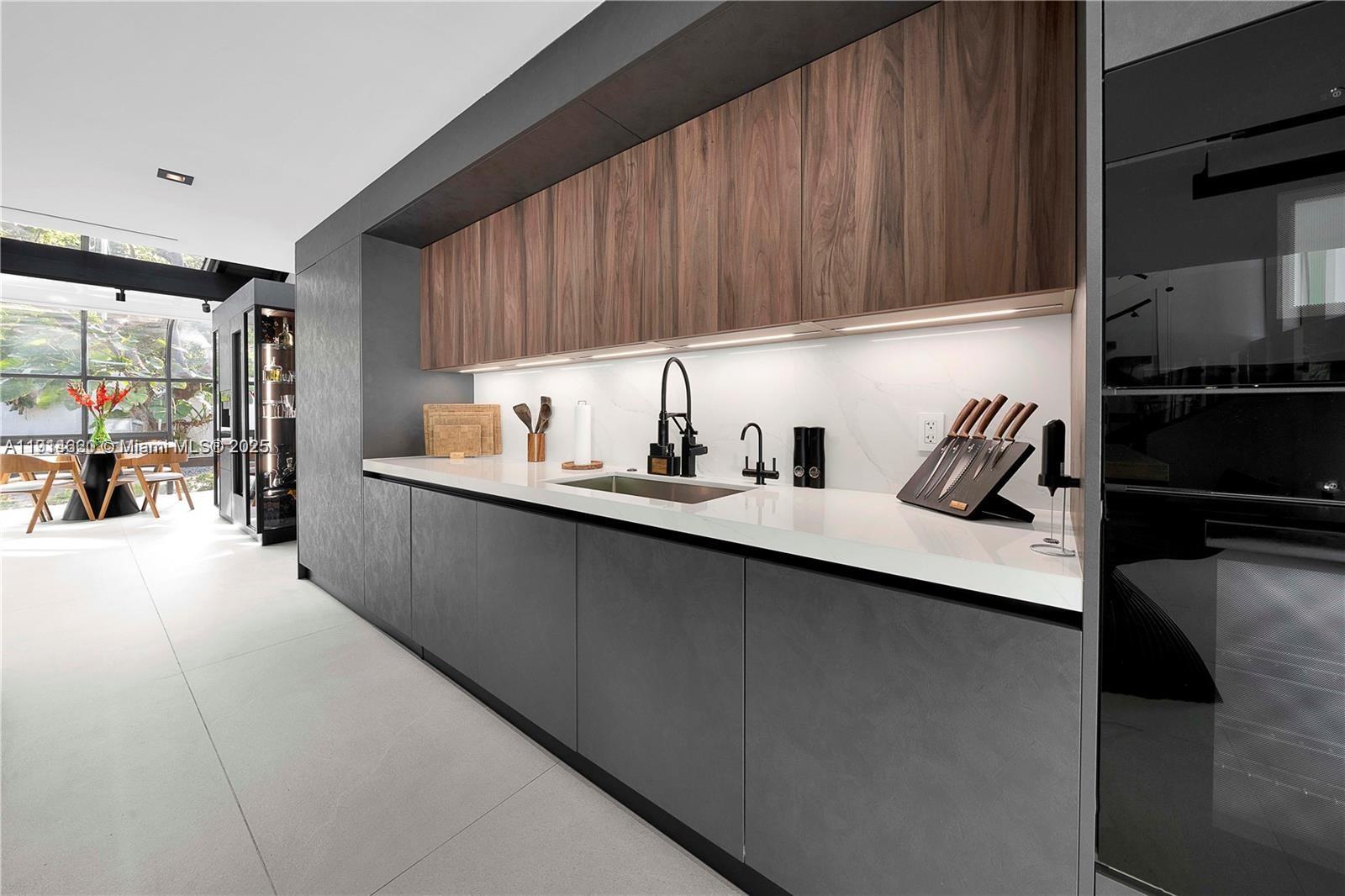 3760 Douglas Road Miami, FL 33133 - Photo 18 of 70 a kitchen with a sink and cabinets