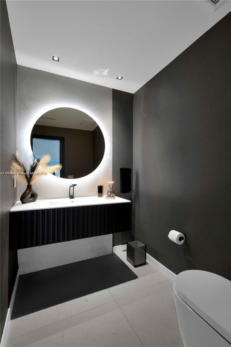 3760 Douglas Road Miami, FL 33133 - Photo 21 of 70 a bathroom with a sink and a mirror