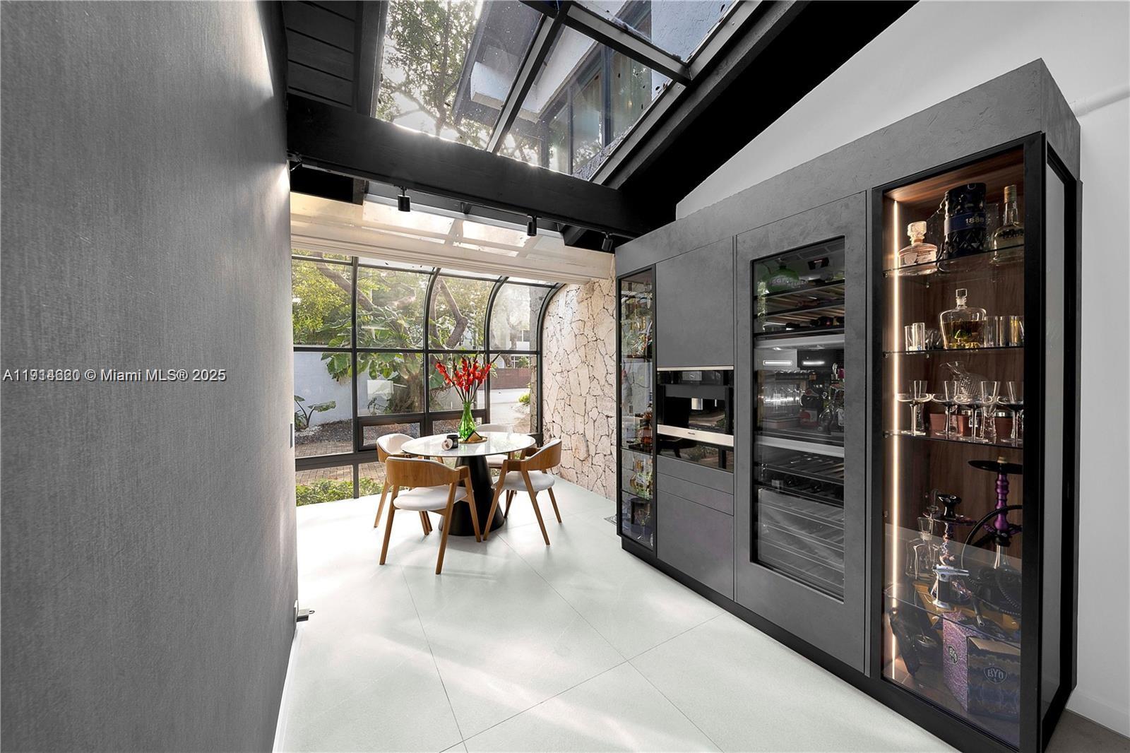 3760 Douglas Road Miami, FL 33133 - Photo 23 of 70 a kitchen with a table chairs and refrigerator