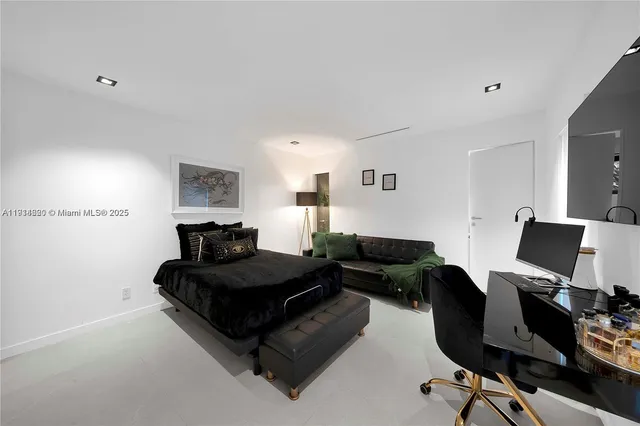 a bedroom with a bed and a couch