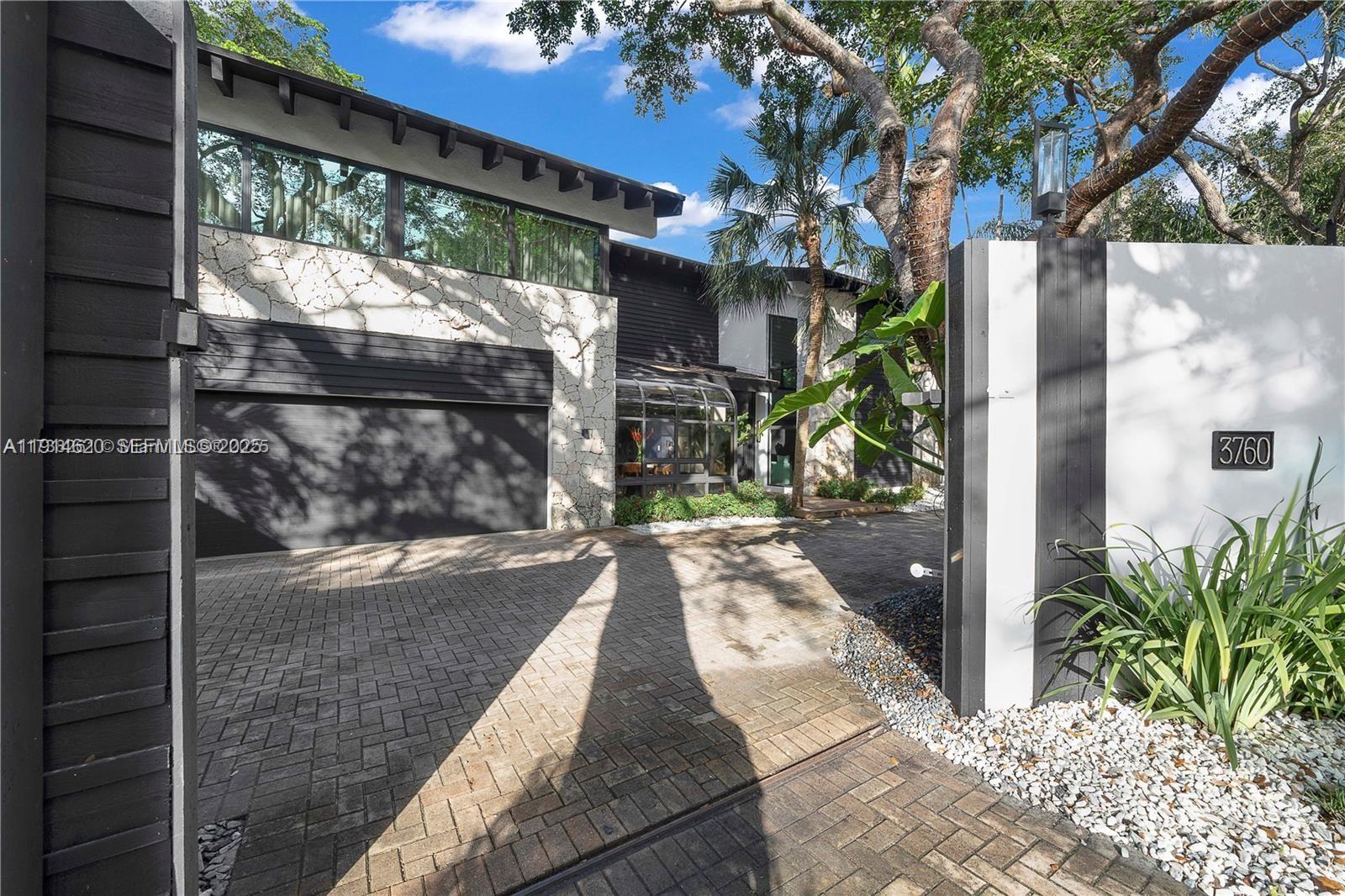 3760 Douglas Road Miami, FL 33133 - Photo 4 of 70 a view of a pathway of a house with a porch