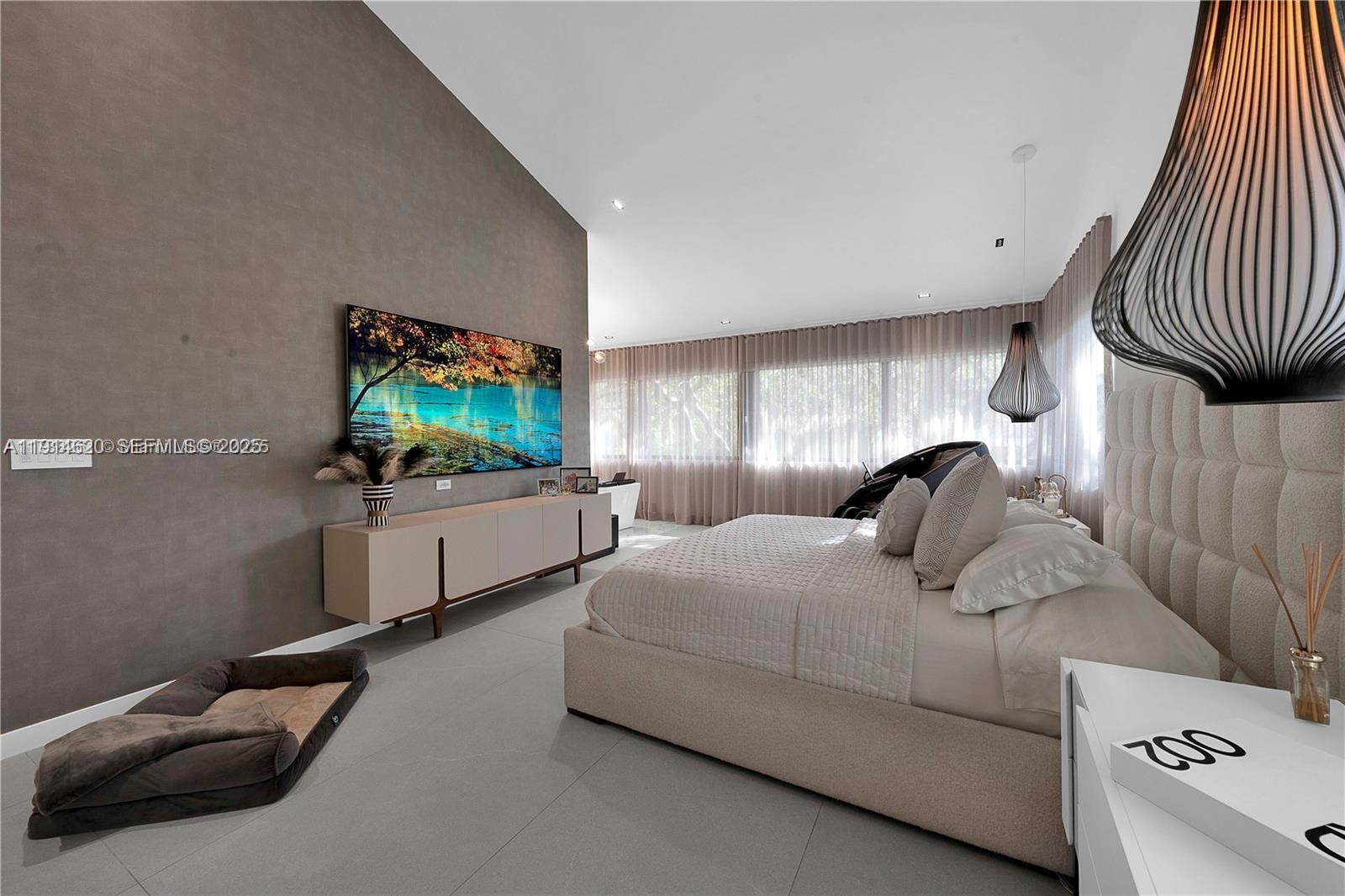 3760 Douglas Road Miami, FL 33133 - Photo 42 of 70 a bedroom with bed and a flat screen tv