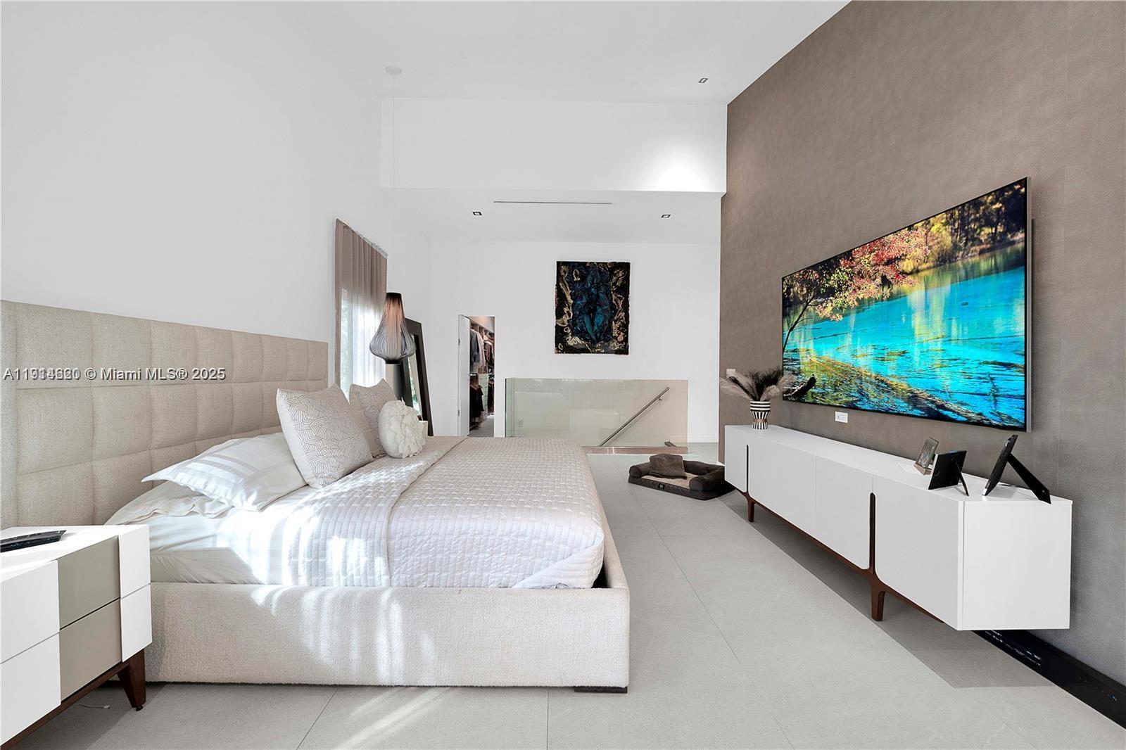 3760 Douglas Road Miami, FL 33133 - Photo 51 of 70 a bedroom with a bed and a flat screen tv