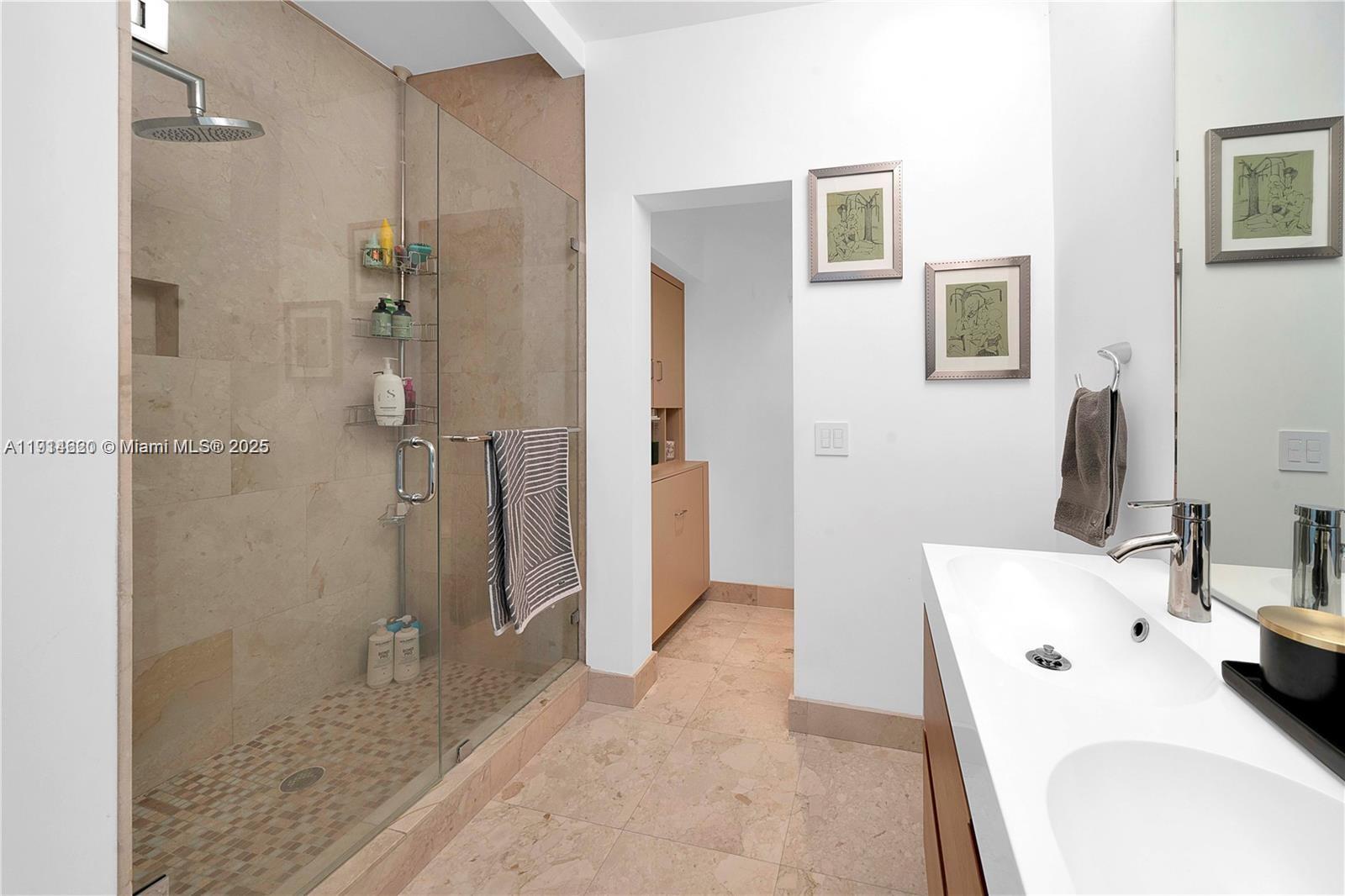 3760 Douglas Road Miami, FL 33133 - Photo 56 of 70 a bathroom with a tub sink and a mirror