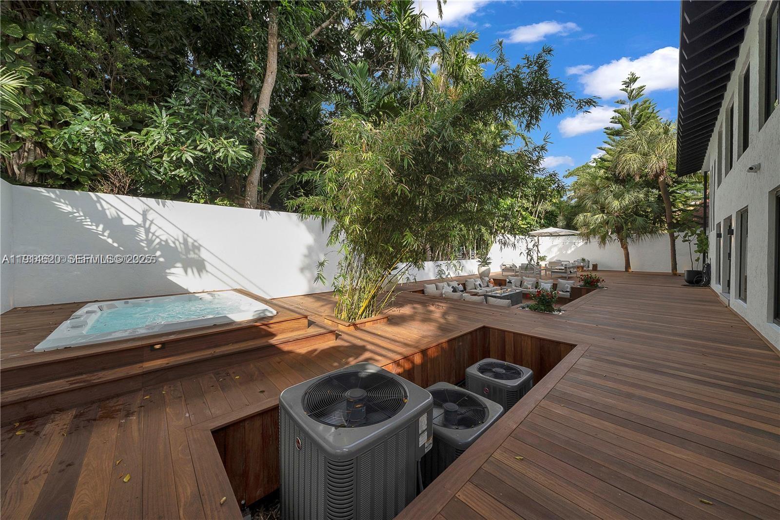 3760 Douglas Road Miami, FL 33133 - Photo 66 of 70 a view of a patio with table and chairs with wooden floor and fence