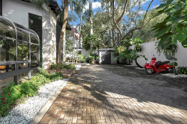 a large kitchen with a large window and stainless steel appliances