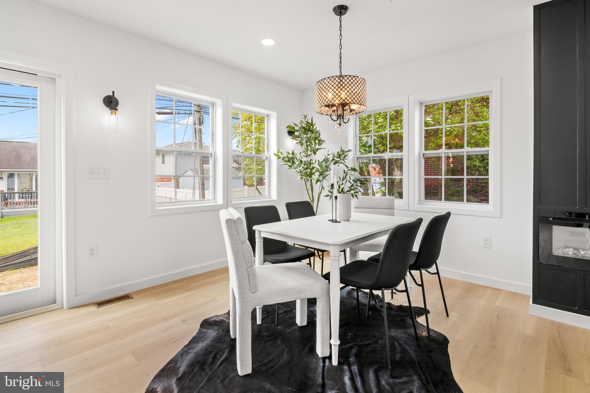 7817 Liberty Road Windsor Mill, MD 21244 - Photo 12 of 50 a view of a dining room with furniture windows and wooden floor