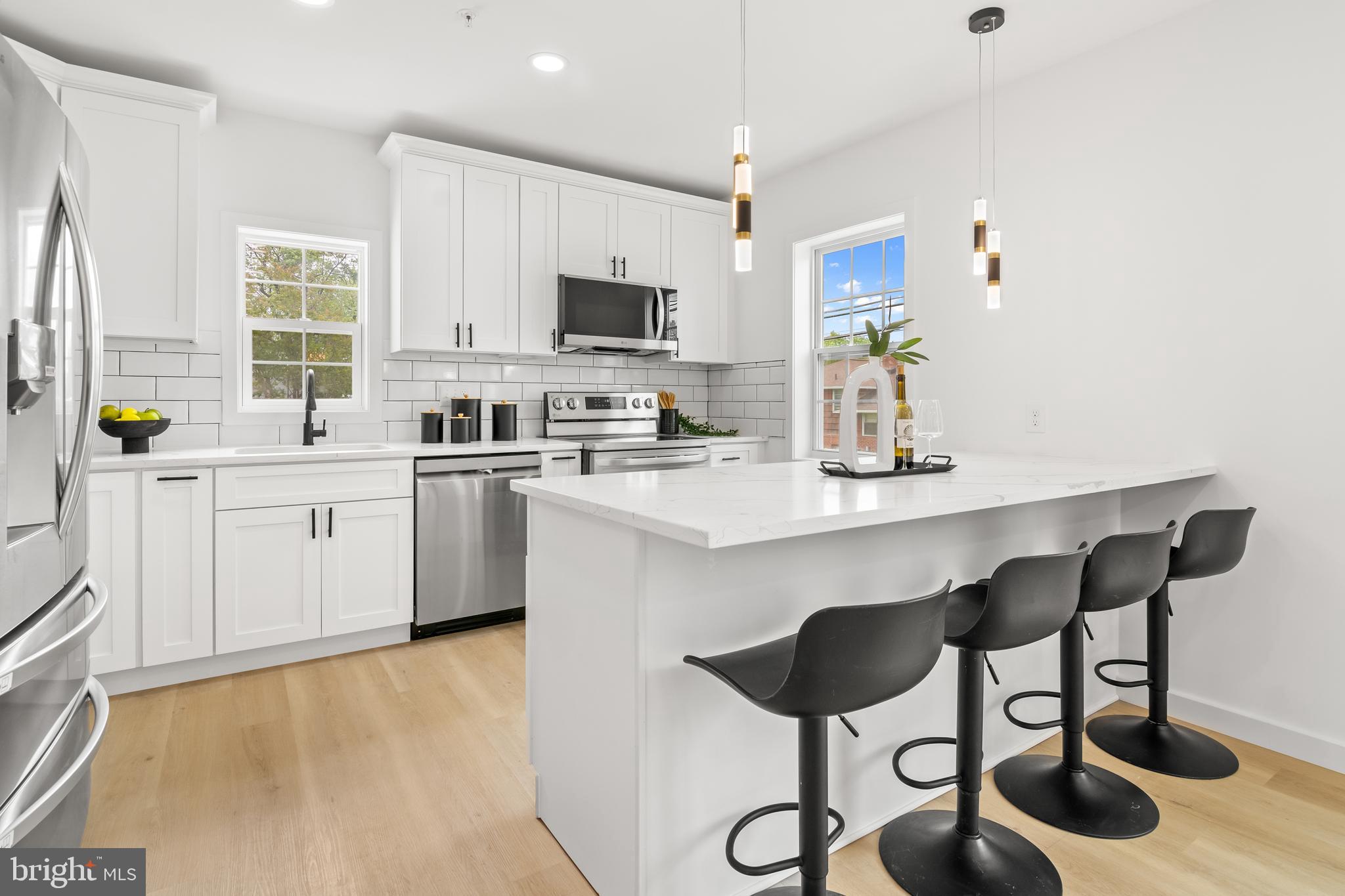 7817 Liberty Road Windsor Mill, MD 21244 - Photo 14 of 50 a kitchen with a sink cabinets and window