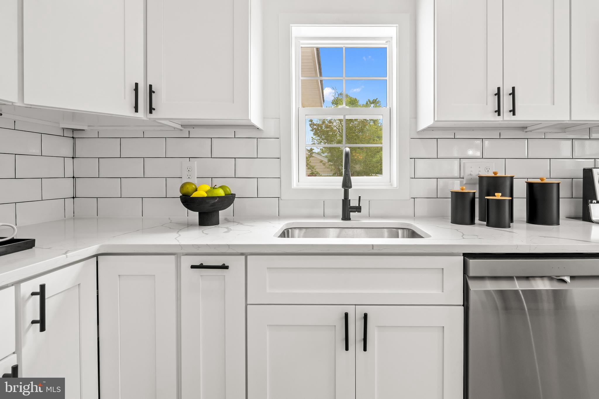 7817 Liberty Road Windsor Mill, MD 21244 - Photo 16 of 50 a kitchen with a sink white cabinets and a window