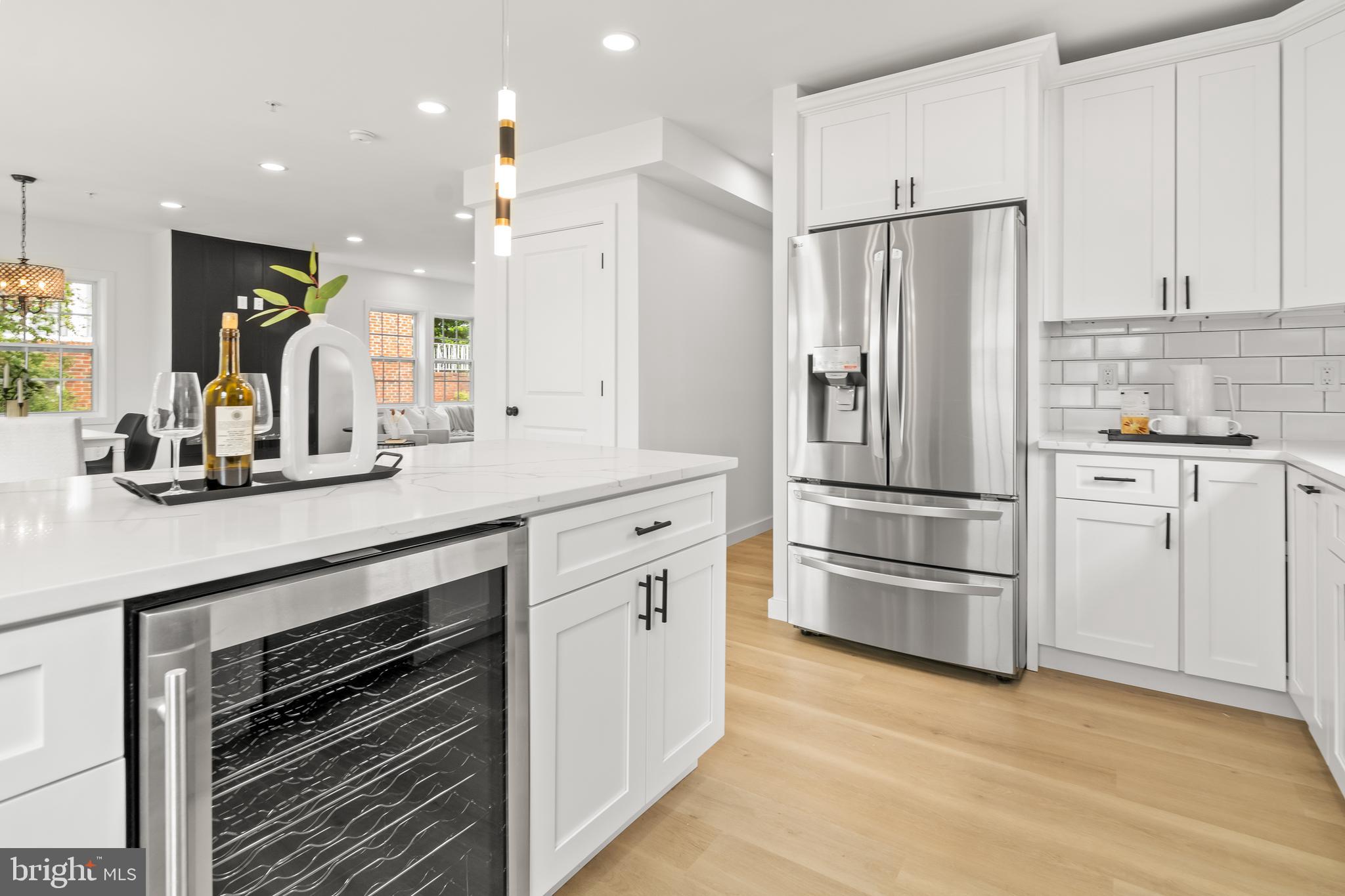 7817 Liberty Road Windsor Mill, MD 21244 - Photo 18 of 50 a kitchen with white cabinets and stainless steel appliances