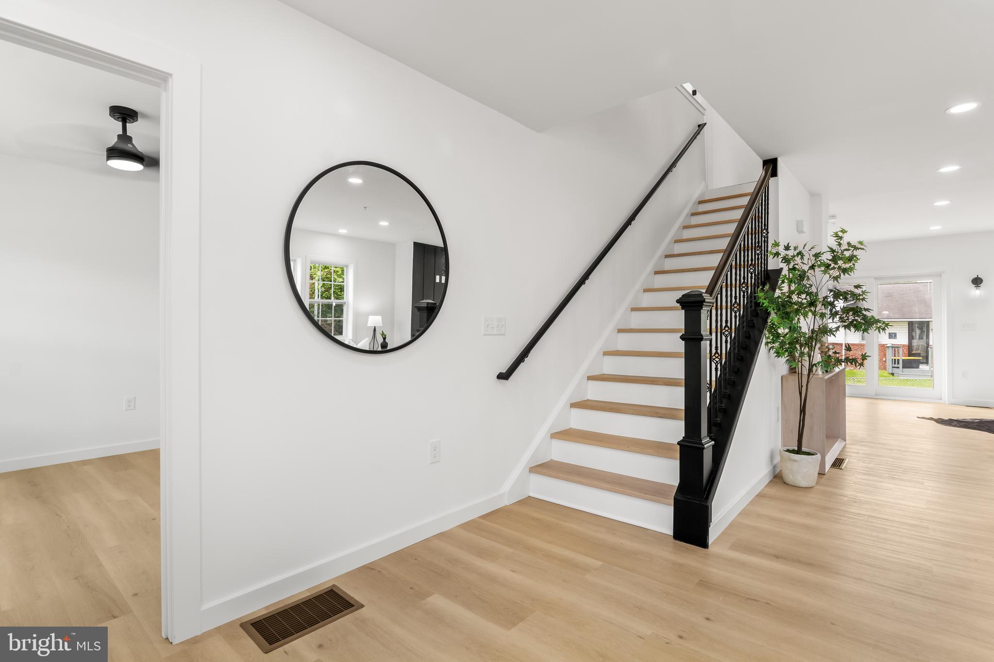 7817 Liberty Road Windsor Mill, MD 21244 - Photo 3 of 50 a view of a hallway with entryway wooden floor and front door