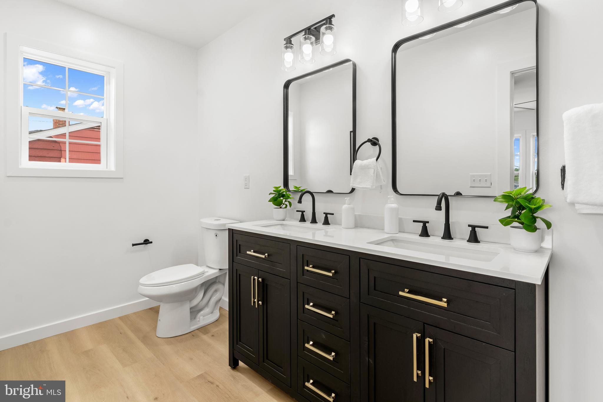 7817 Liberty Road Windsor Mill, MD 21244 - Photo 32 of 50 a bathroom with a double vanity sink mirror and toilet