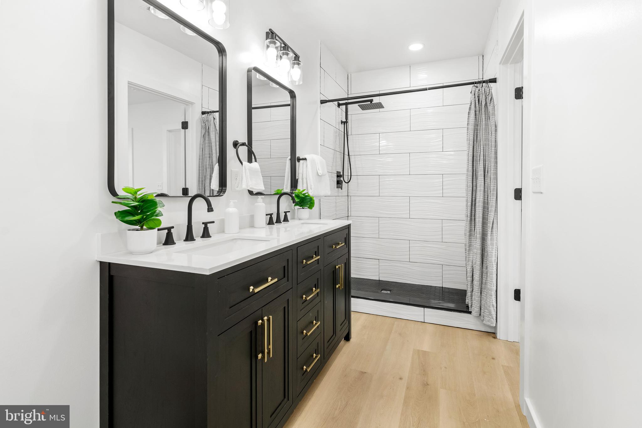 7817 Liberty Road Windsor Mill, MD 21244 - Photo 33 of 50 a bathroom with a double vanity sink and shower