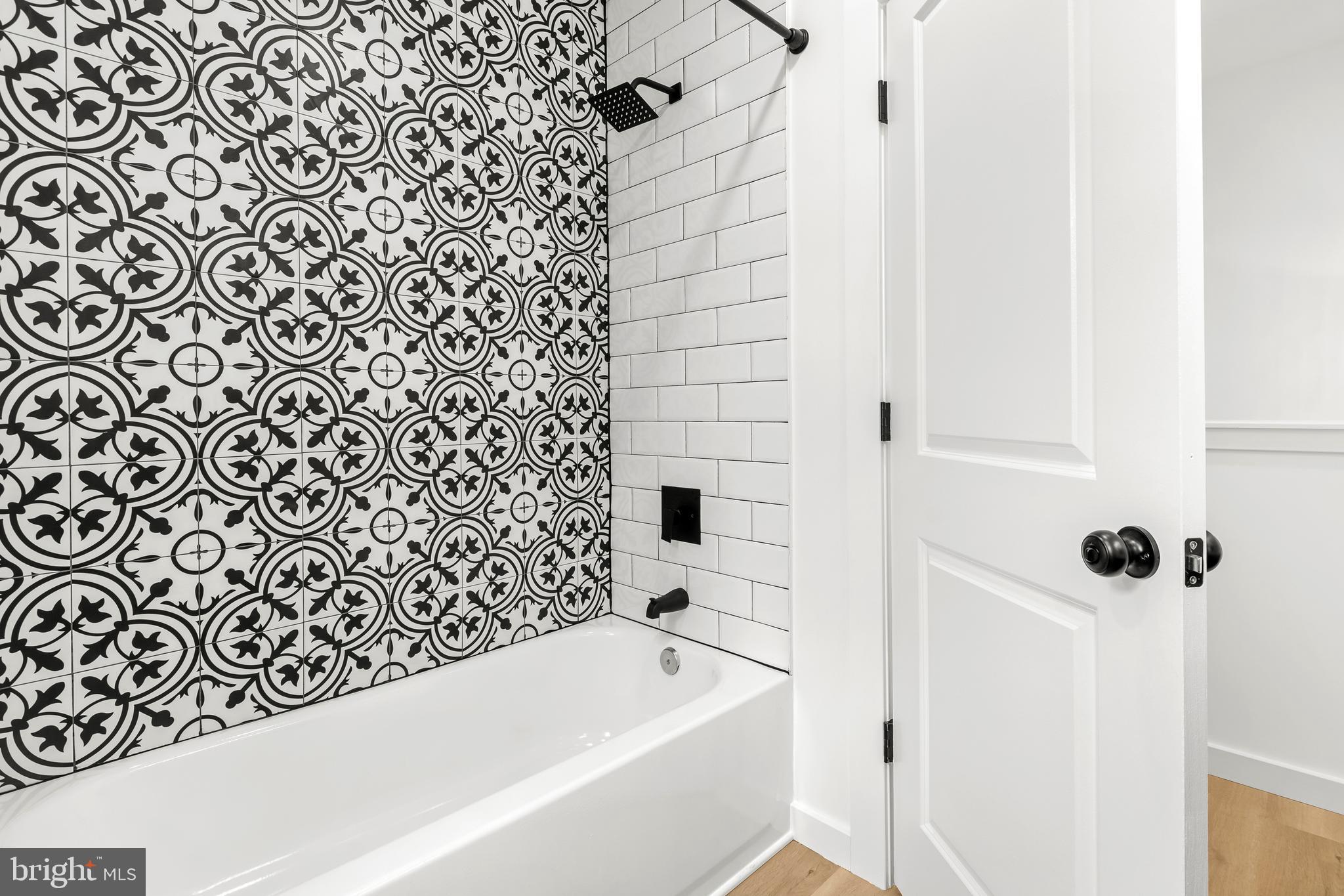 7817 Liberty Road Windsor Mill, MD 21244 - Photo 38 of 50 a bathroom with a bathtub and shower