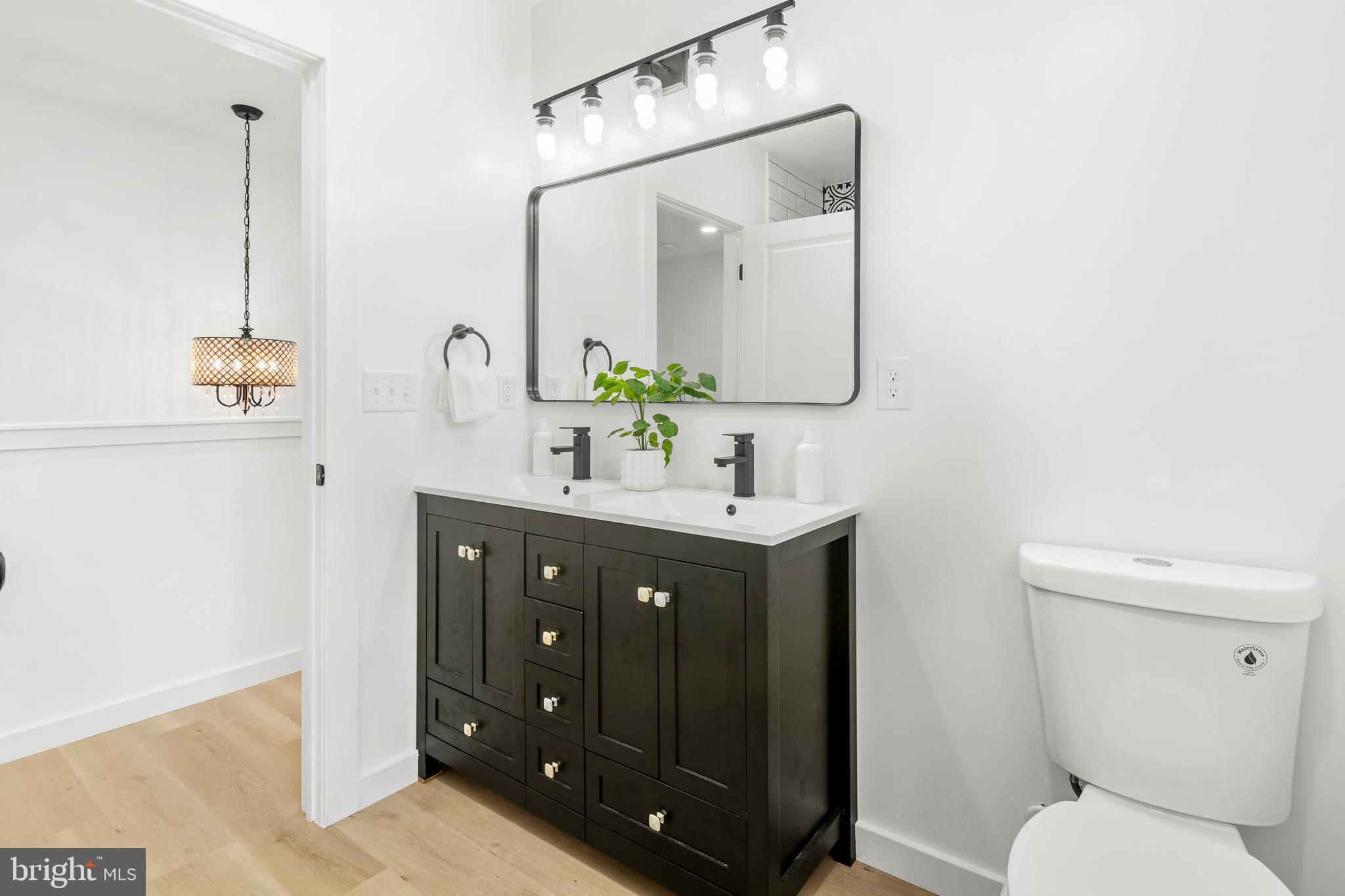 7817 Liberty Road Windsor Mill, MD 21244 - Photo 39 of 50 a bathroom with a double vanity sink and a mirror