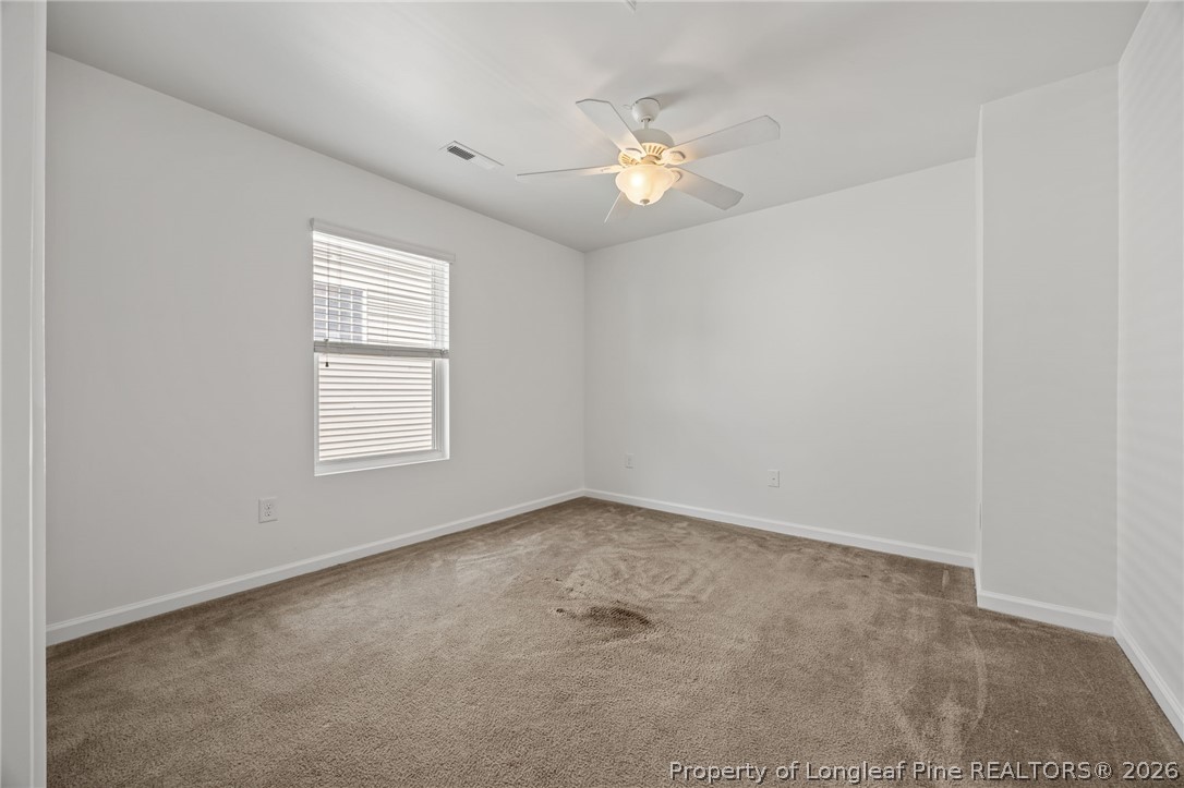 226 River Oak Street Spring Lake, NC 28390 - Photo 32 of 41 an empty room with windows and chandelier fan
