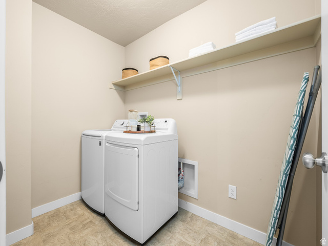834 West 1050th Street South Springville, UT 84663 - Photo 16 of 26 Dedicated laundry area featuring a shelf for storage, neutral wall paint, and durable flooring