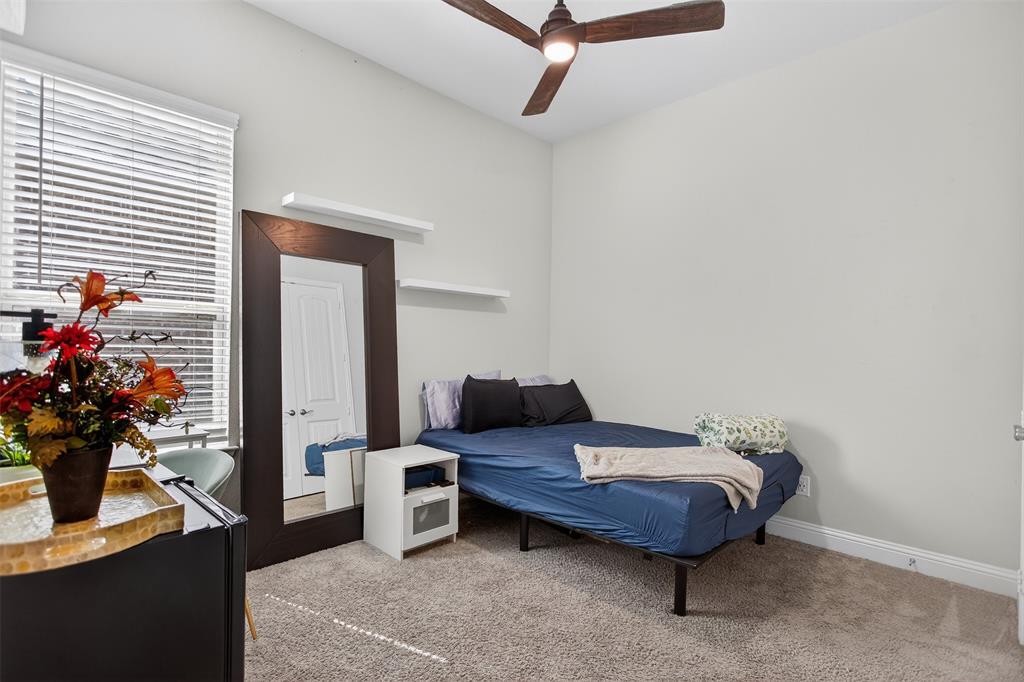 6829 Danridge Road Rowlett, TX 75089 - Photo 17 of 28 a bedroom with furniture and potted plant