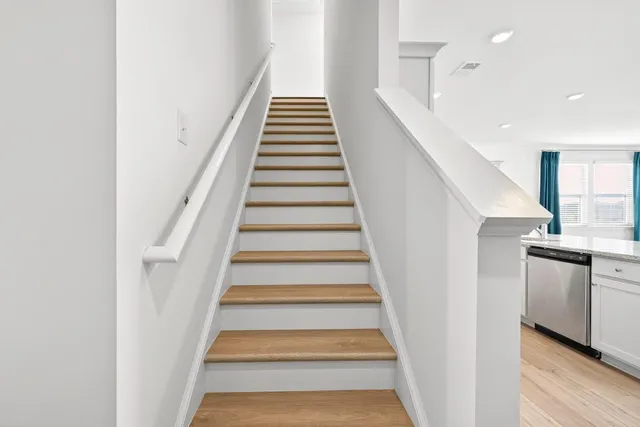 a view of an entryway with wooden floor