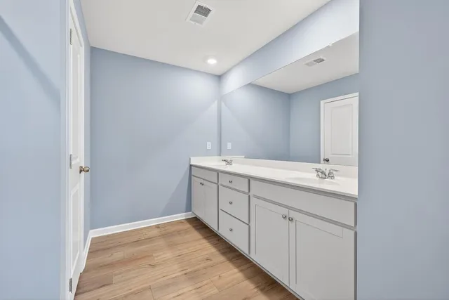 a bathroom with a double vanity sink and mirror