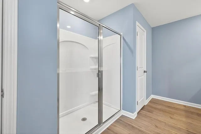 a bathroom with a glass shower door