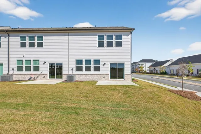 a house that has a swimming pool in front of it