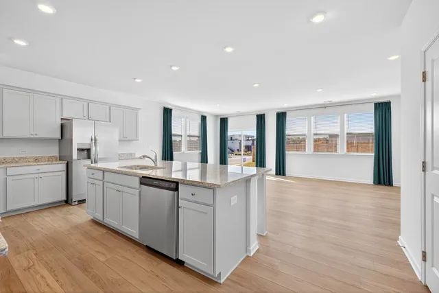 a kitchen with stainless steel appliances granite countertop a stove and a refrigerator
