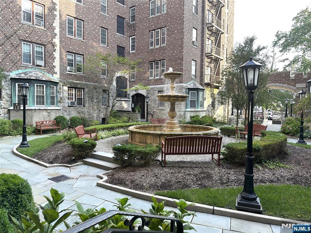 275 Engle Street, Unit J4 Englewood, NJ 07631 - Photo 12 of 12 a view of a brick house with a yard and plants