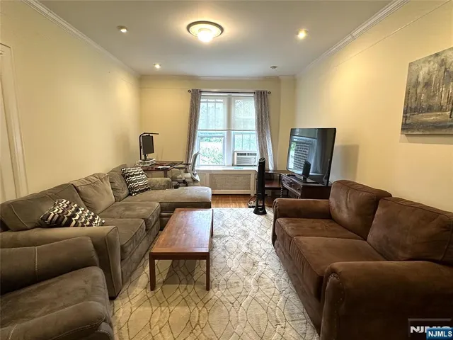 a living room with furniture a couch and a flat screen tv
