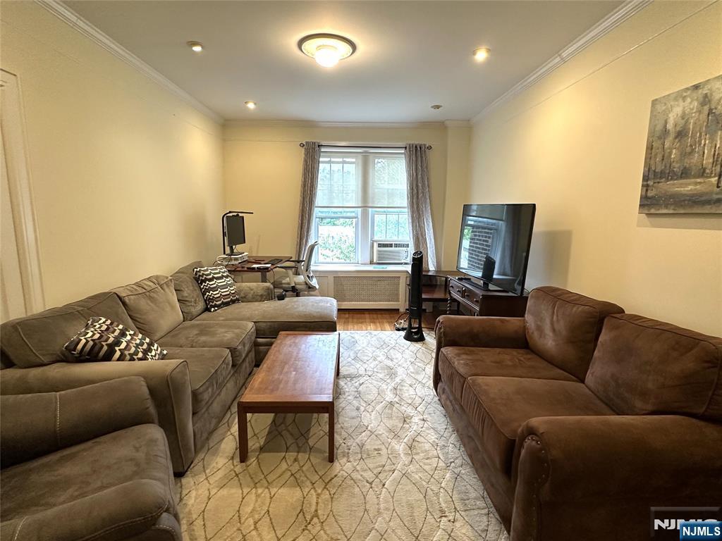 275 Engle Street, Unit J4 Englewood, NJ 07631 - Photo 6 of 12 a living room with furniture a couch and a flat screen tv