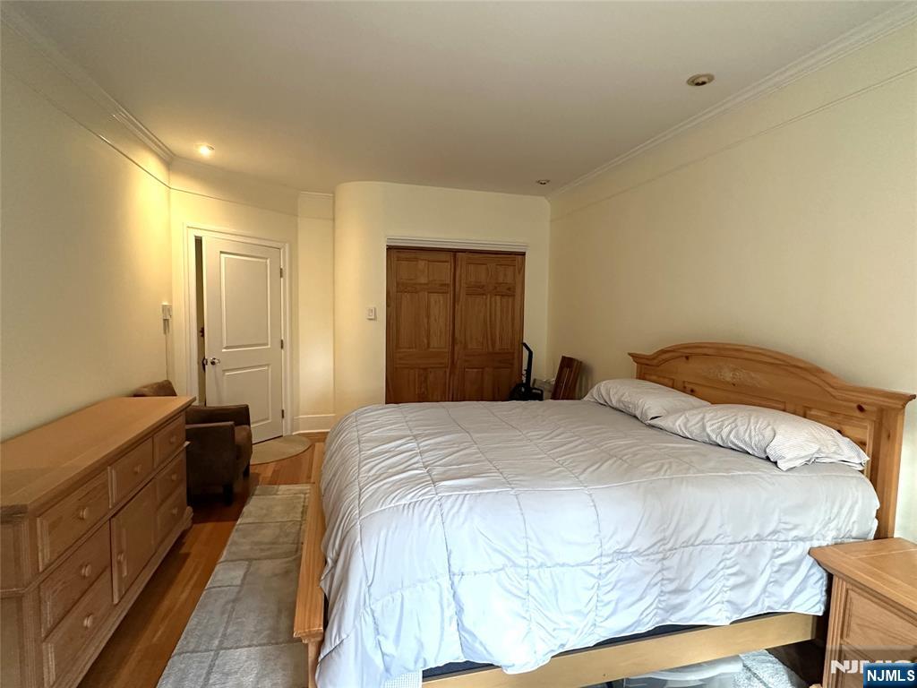 275 Engle Street, Unit J4 Englewood, NJ 07631 - Photo 9 of 12 a bedroom with a bed and a dresser