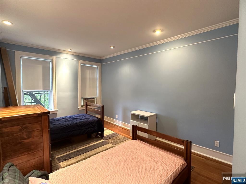 275 Engle Street, Unit J4 Englewood, NJ 07631 - Photo 10 of 12 a bedroom with a bed and a window