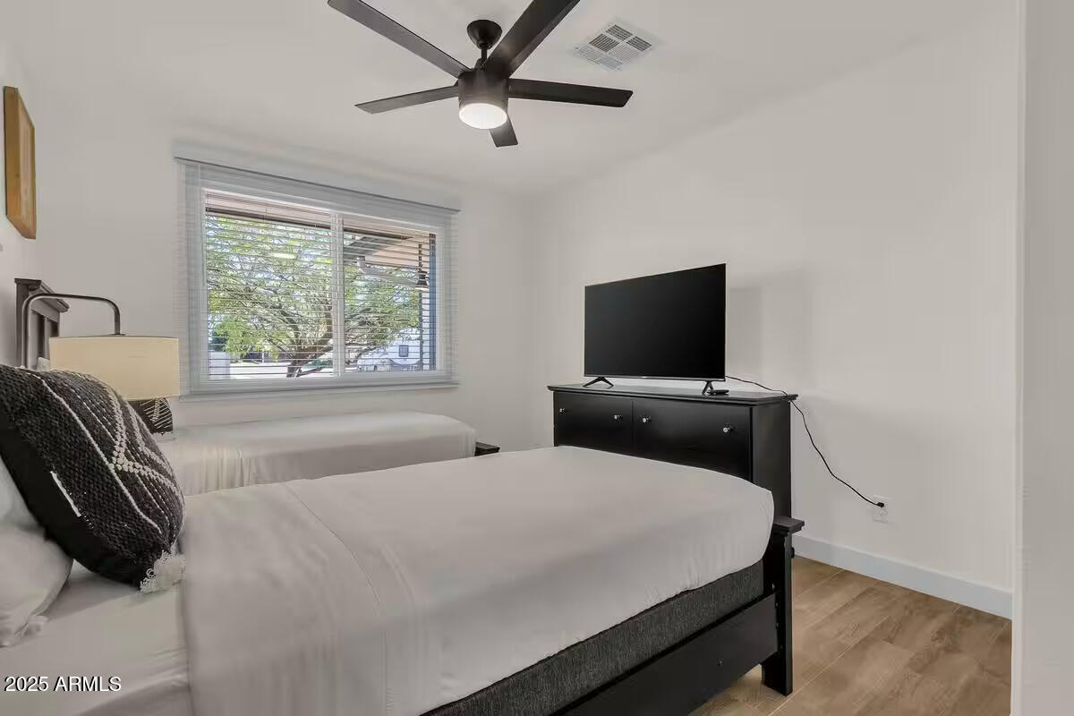 2452 East Manhatton Drive Tempe, AZ 85282 - Photo 11 of 25 a bedroom with a bed and a flat screen tv