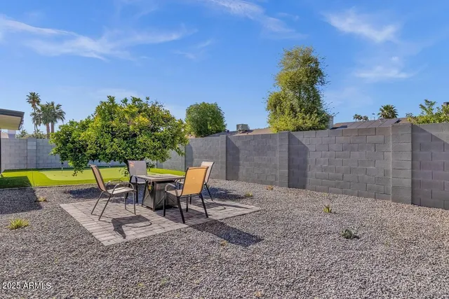 a swimming pool with outdoor seating and yard