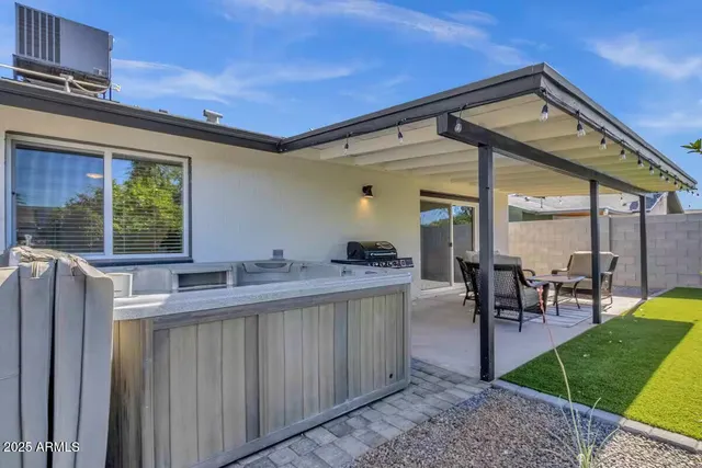 a kitchen with kitchen island a large window in it and dining table