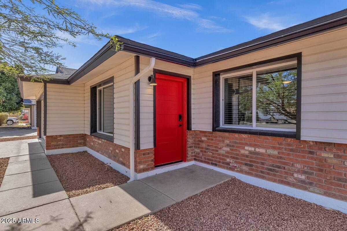 2452 East Manhatton Drive Tempe, AZ 85282 - Photo 18 of 25 a view of a house with door and wooden walls