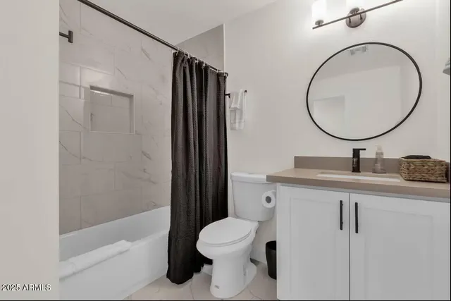 a bathroom with a toilet a sink and a mirror