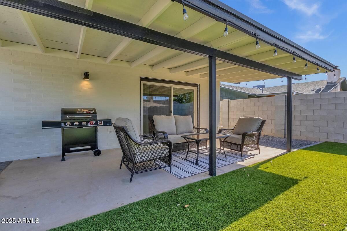 2452 East Manhatton Drive Tempe, AZ 85282 - Photo 4 of 25 a view of a patio with table and chairs