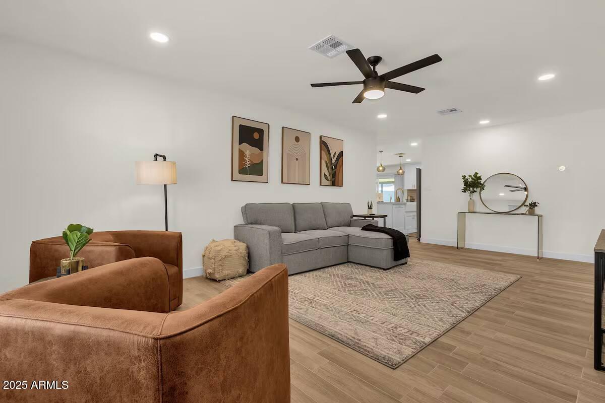 2452 East Manhatton Drive Tempe, AZ 85282 - Photo 7 of 25 a bedroom with a bed and ceiling fan