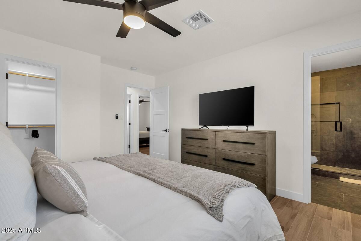 2452 East Manhatton Drive Tempe, AZ 85282 - Photo 9 of 25 a bedroom with a bed and a flat screen tv