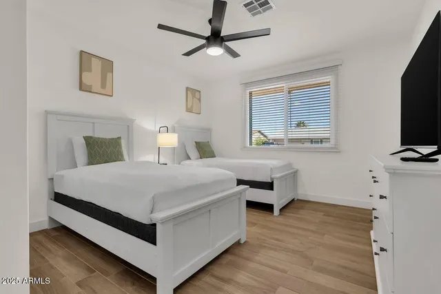 a bedroom with a bed and a flat screen tv