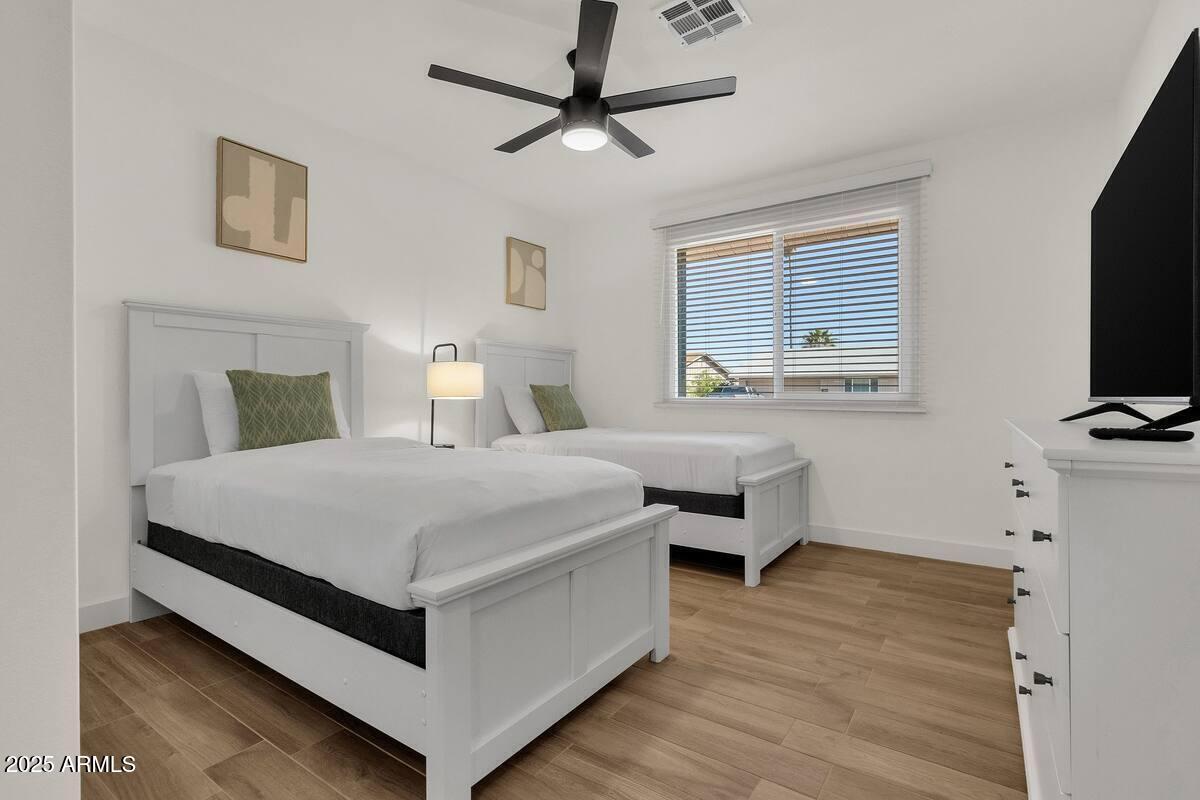 2452 East Manhatton Drive Tempe, AZ 85282 - Photo 10 of 25 a bedroom with a bed and a flat screen tv