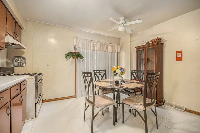 a view of a dining room with furniture and a chandelier
